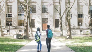 a couple of people that are standing in front of a building