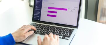 a person using a laptop computer on a desk