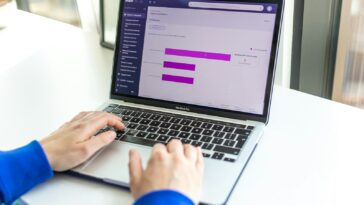 a person using a laptop computer on a desk