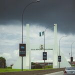 A car driving down a highway under a cloudy sky