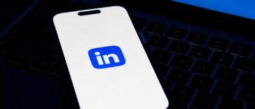 a phone sitting on top of a laptop computer