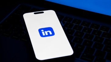 a phone sitting on top of a laptop computer