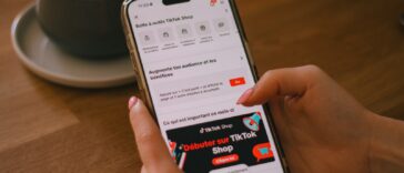 A person uses a phone with the tiktok shop app.