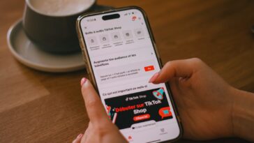 A person uses a phone with the tiktok shop app.