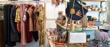assorted-colored clothes on rack near brown wooden table