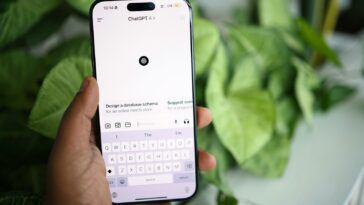 a person holding a cell phone in their hand