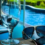 empty goblet beside sunglasses