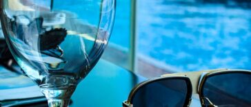 empty goblet beside sunglasses