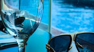 empty goblet beside sunglasses