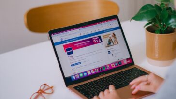 A person sitting at a desk with a laptop