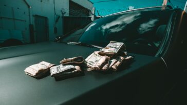 black car parked beside white building during daytime