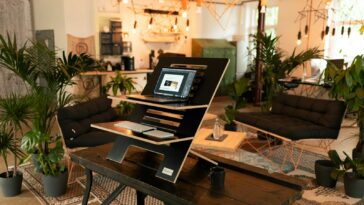 a laptop computer sitting on top of a wooden table