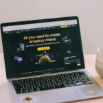 A laptop computer sitting on top of a white table