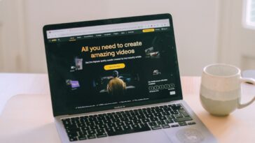 A laptop computer sitting on top of a white table