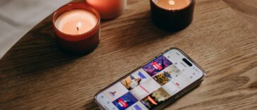 a cell phone sitting on top of a wooden table
