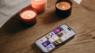 a cell phone sitting on top of a wooden table
