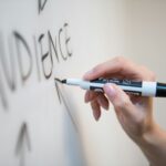 person holding white and blue click pen