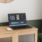 A laptop is displaying video editing software.