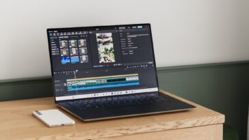 A laptop is displaying video editing software.