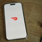 A cell phone sitting on top of a wooden table