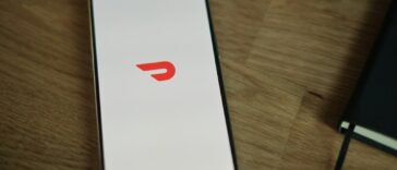 A cell phone sitting on top of a wooden table