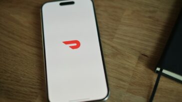 A cell phone sitting on top of a wooden table