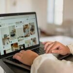 a person using a laptop computer on a desk