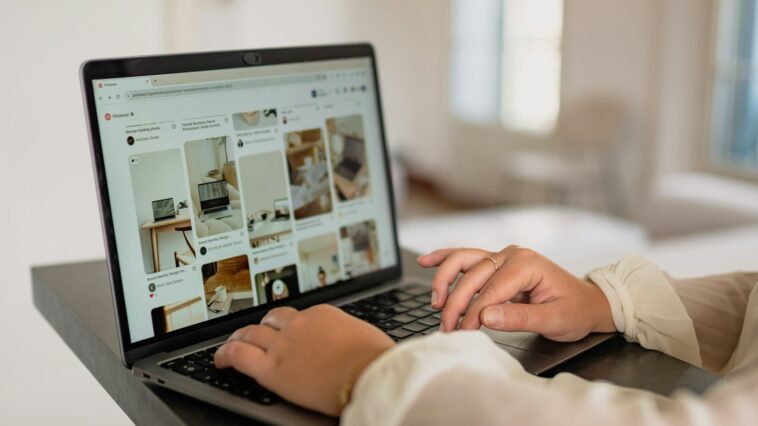 a person using a laptop computer on a desk