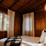 a bed in a room with wooden walls