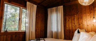 a bed in a room with wooden walls