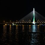 a large bridge over a body of water at night