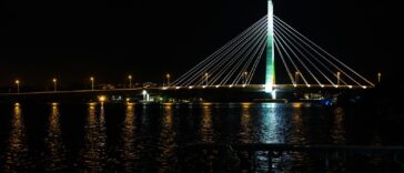 a large bridge over a body of water at night