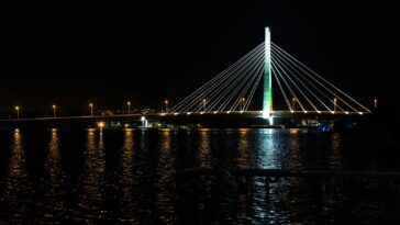 a large bridge over a body of water at night